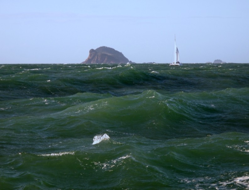 Standing up waves off Split Island, Queensland. 25 knot winds against 4 knot tidal flow. Grainger 1250 catamaran in background.