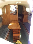 inside cabin. two burner stove. ice box, tiny sink, some drawers and a head!