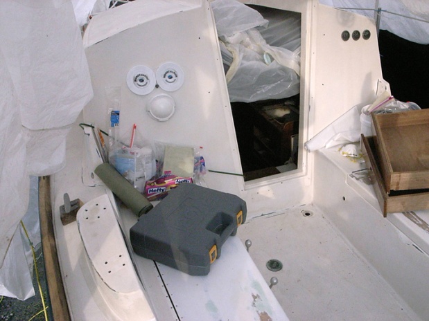 Cockpit with companionway boards, teak trim removed for refinishing and rebedding. Also removed teak coaming for same.