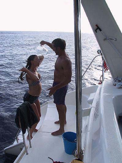 Me giving a 25 week pregnant Christa a fresh water shower off the back of the boat in Saba - Leeward Islands Caribbean