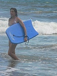 Christa boogie boarding on the beach in Costa Rica