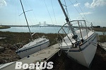 Just like I left her, but 50 yards from the water. As you can see, the marina is nothing but lonely pilings. The photographer for Boat US said if I...