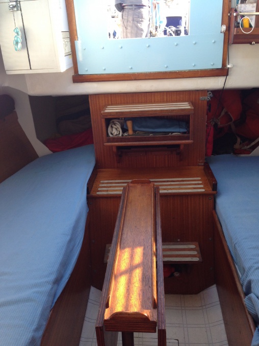Original table. Note access to hatches through the settees. The previous owner mounted the extra enclosure there to the companionway. I actually like it, it stays dry and no chance of water intrusion if we get the cockpit flooded.