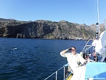 Heading east between Fry's Harbor and Orizaba anchorage, Platt's harbor is behind the boat there at the base of the cliff and to the right, north...