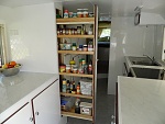 Starboard side of galley, with open slide out cupboard