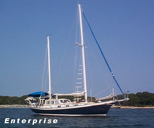 Caption:Enterprise, hull number 99, a Newporter 40 built at the Stowman Shipyard in Dorchester, NJ, in 1964. The Newporters are 40 foot on the deck, 13 foot beam, Ketch rigged and of approximately 24,000 lbs displacement.  Construction consists of oak framing with fir plywood planking covered with fiberglass. Power is a 59 HP Ford tractor diesel converted for marine use. Fuel and water tankage is 130 gallons of diesel and 155 gallons of water.