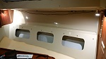 Storage pockets cut into areas behind setee cushions and also in vberth, on both port and starboard sides.
