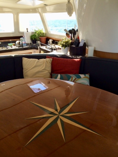 Saloon large dinning table looking towards galley, small coffee table in under the large table.