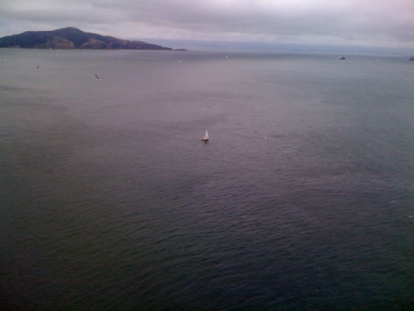 That is me on my little white boat with my dinghy trailing behind just having passed under the GG bridge.  I sailed from Half Moon Bay to San Francisco by myself!  So pleased.  A friend took the picture from the bridge.