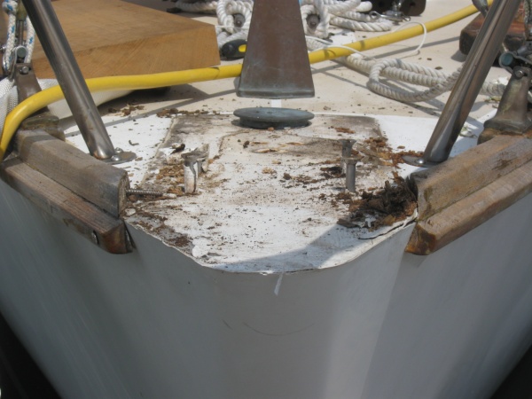 Got to cut the bolts off, totally frozen (flat heads bite!). Hopefully going to get bronze carriage, if not then 316 carriage bolts to replace. See my pretty new teak in the background?
From what I can tell, Cape dory fiberglasses the deck to hull joint in the bow, and used solid glass for the first 2 - 3 feet (past the hawse pipe - cool). There is also a triangular stainless steel plate that fits up into the point of the bow whichs acts as a huge backing plate for the forstay, babystay, and bowsprit (way cool)