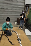 Welding the frame parts, which are aligned with a  router cut MDF board template.