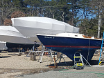 The old hull color before our son Awlgripped the hull.  Big white shrink wrapped boat is Averisera, our old boat.