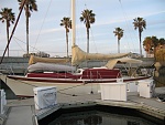 Port side with covers, with old mainsail cover and old canvas.  She now has a new main sail cover and a new dodger, bimini and connector.  Dodger...