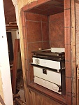 Stove and oven in a little tile nook.