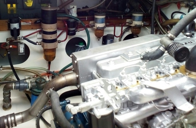 Engine close up. Fuel polishing system in background. From left to right. High speed transfer pump. Large 2 micron filter. Then comes engine fuel supply. The black item is external engine fuel pump that draws fuel through two Racor filters. Since adding the fuel polishing system, the fuel supply filters rarely need to be replaced.