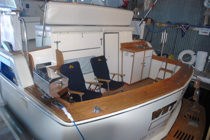 Stern View - custom tackle center - The seating on deck is convertible so guests can sit facing forward or to the stern.  Great when fishing or swimming